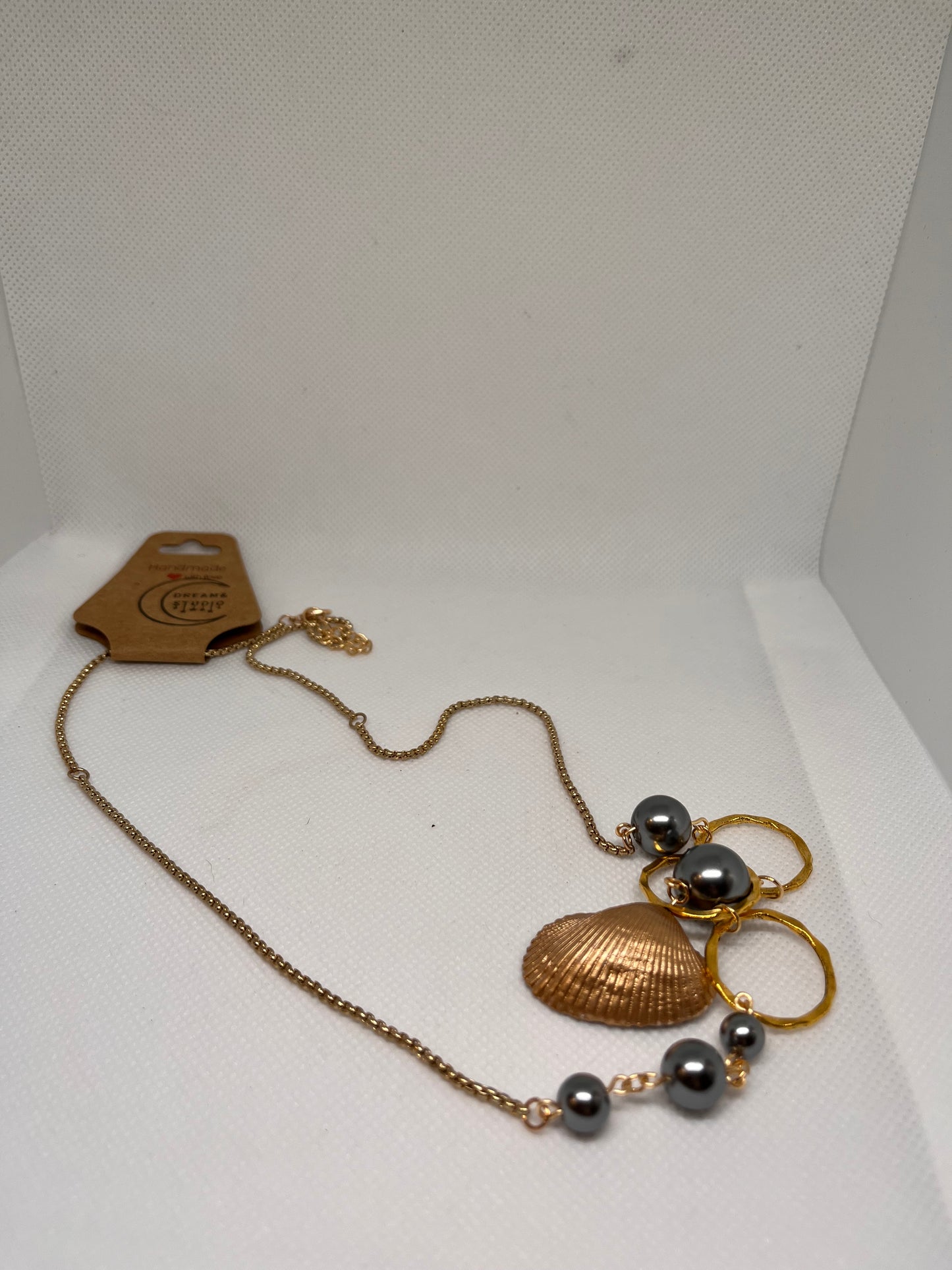 Triple Hammered Gold Circle with Grey Pearl Beads in a Gold Seashell Necklace