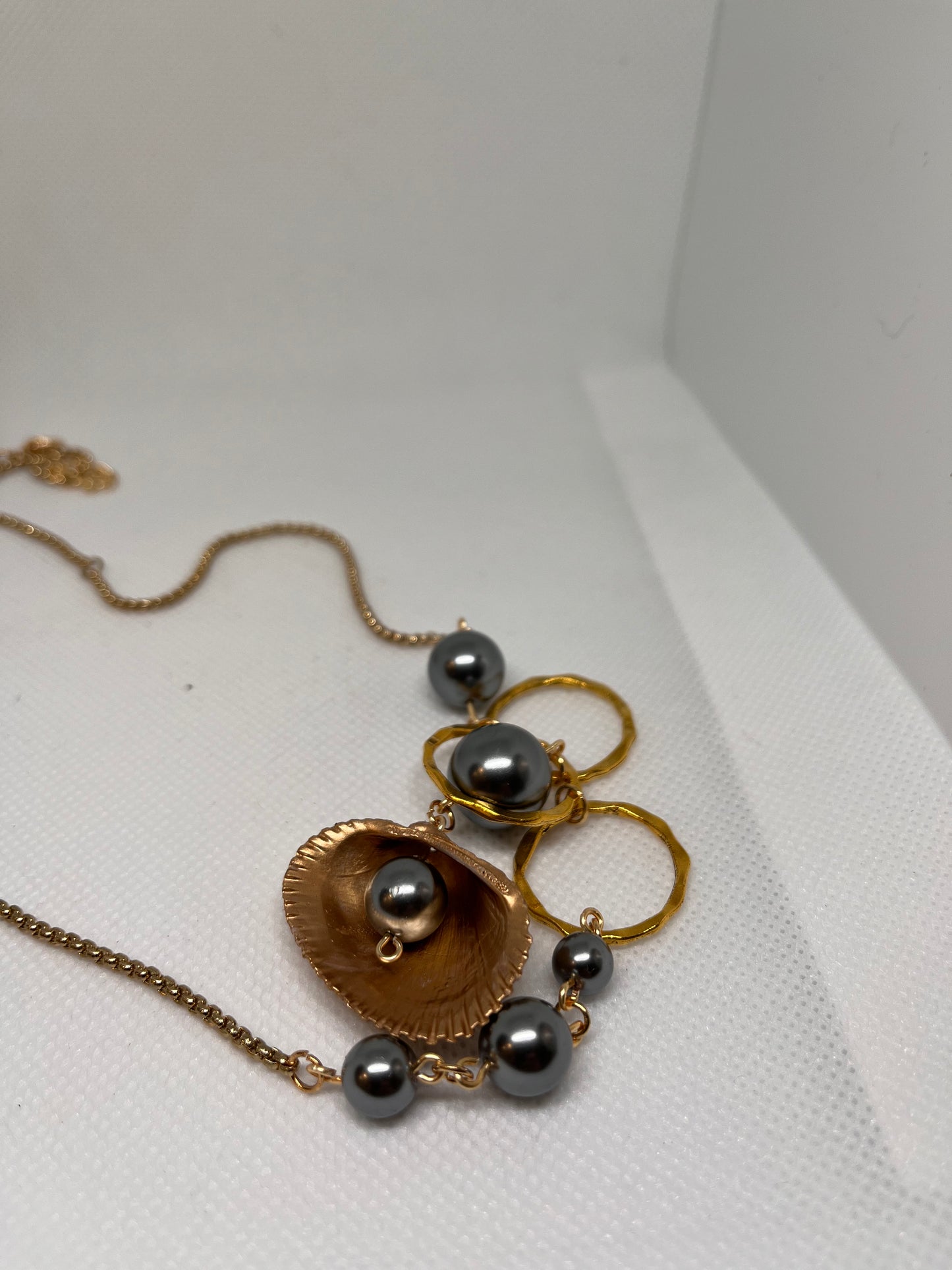 Triple Hammered Gold Circle with Grey Pearl Beads in a Gold Seashell Necklace