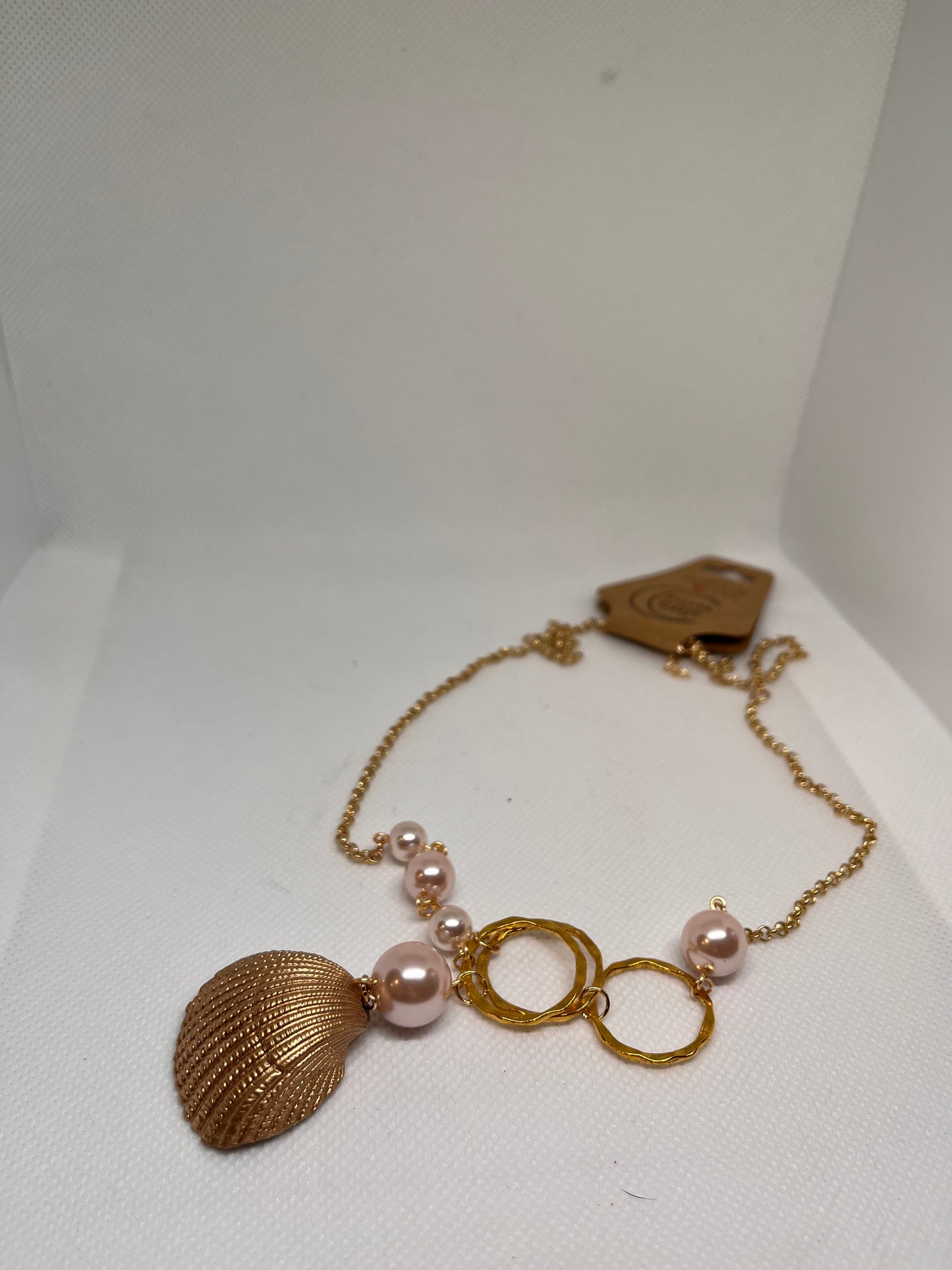 Triple Hammered Gold Circle with Pink Pearl Beads in a Gold Seashell Necklace