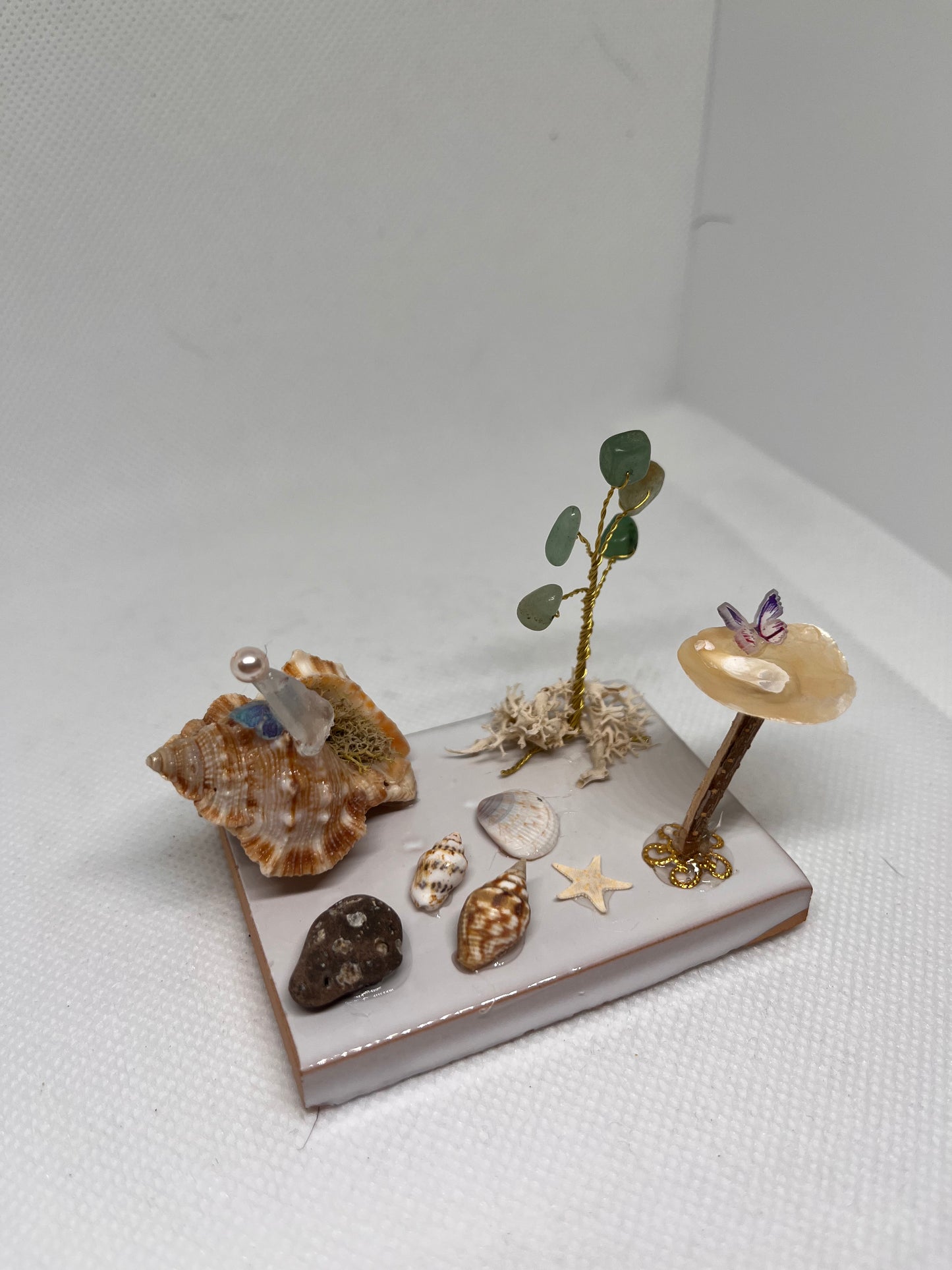 White Sea Glass Fairy Cottage Conch Shell w/ Bird Bath and Aventurine Tree on White Tile