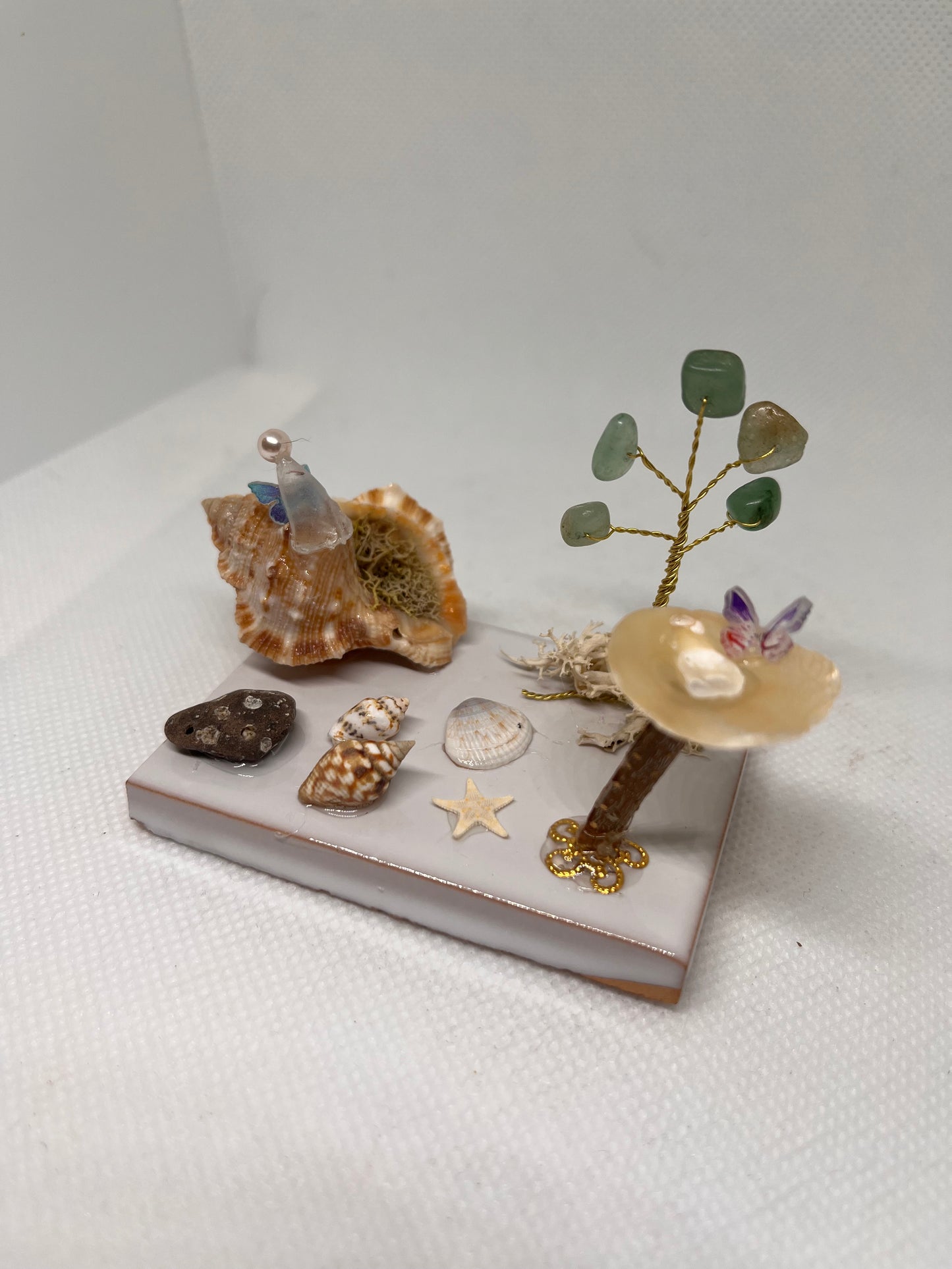 White Sea Glass Fairy Cottage Conch Shell w/ Bird Bath and Aventurine Tree on White Tile