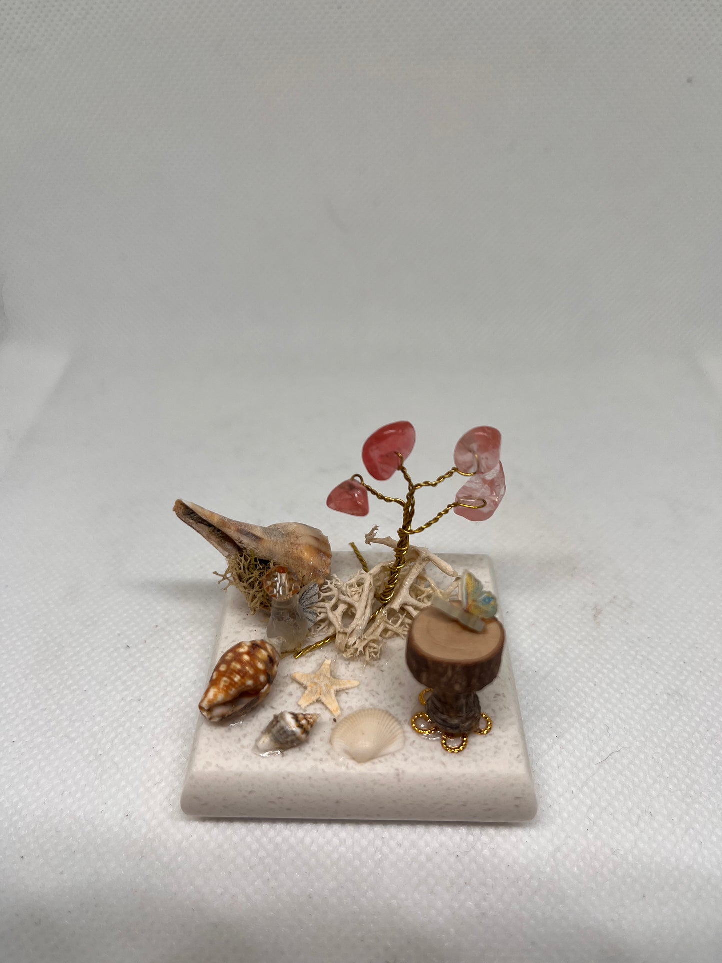 Small White Sea Glass Fairy Cottage Conch Shell w/ Sea Shell Scene, Wood Slice Table, and Aventurine Tree on Marbled Tile