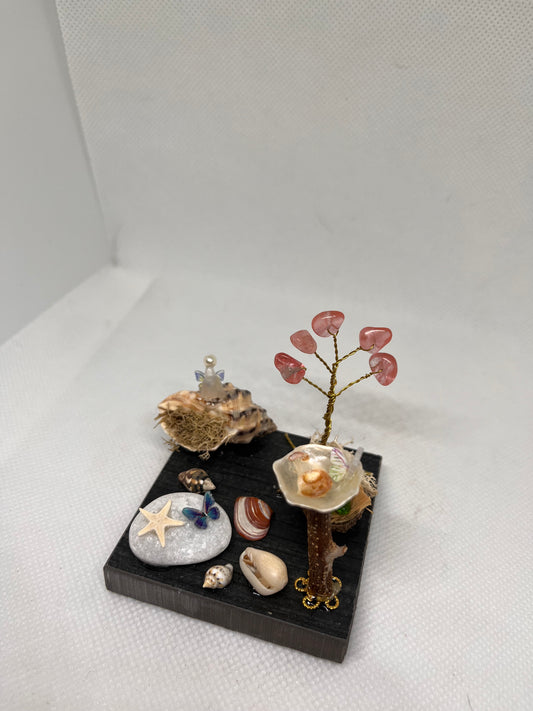 White Sea Glass Fairy Cottage Conch Shell w/ Bird Bath and Watermelon Quartz Tree on Dark Tile