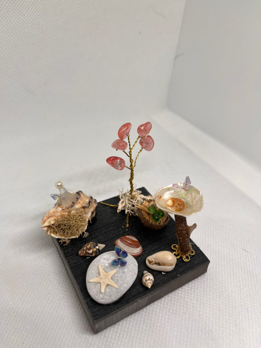 White Sea Glass Fairy Cottage Conch Shell w/ Bird Bath and Watermelon Quartz Tree on Grey Tile