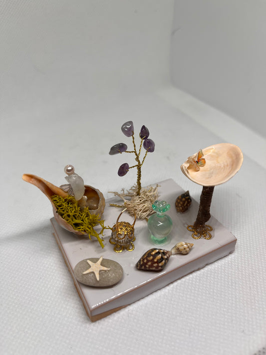 White Sea Glass Fairy Cottage Conch Shell w/ Bird Bath, Lantern, Vase, and Amethyst Tree on White Tile