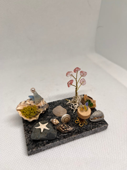 White Sea Glass Fairy Cottage Conch Shell w/ Wood Slice Table, Bird Nest, and Watermelon Quartz Tree on Marble Tile