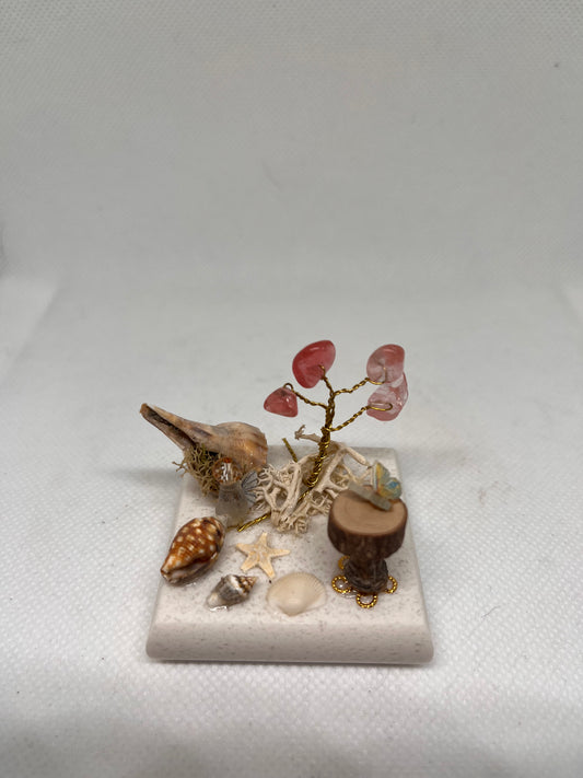 Small White Sea Glass Fairy Cottage Conch Shell w/ Sea Shell Scene, Wood Slice Table, and Aventurine Tree on Marbled Tile